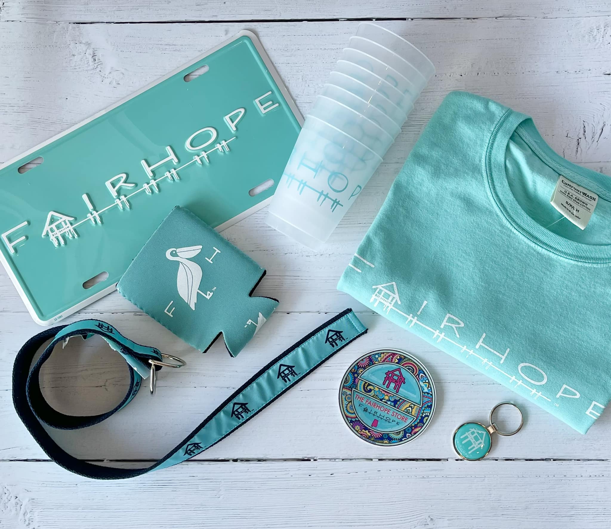 fairhope store merch - t shirt, key chain, cups, koozie, coasters