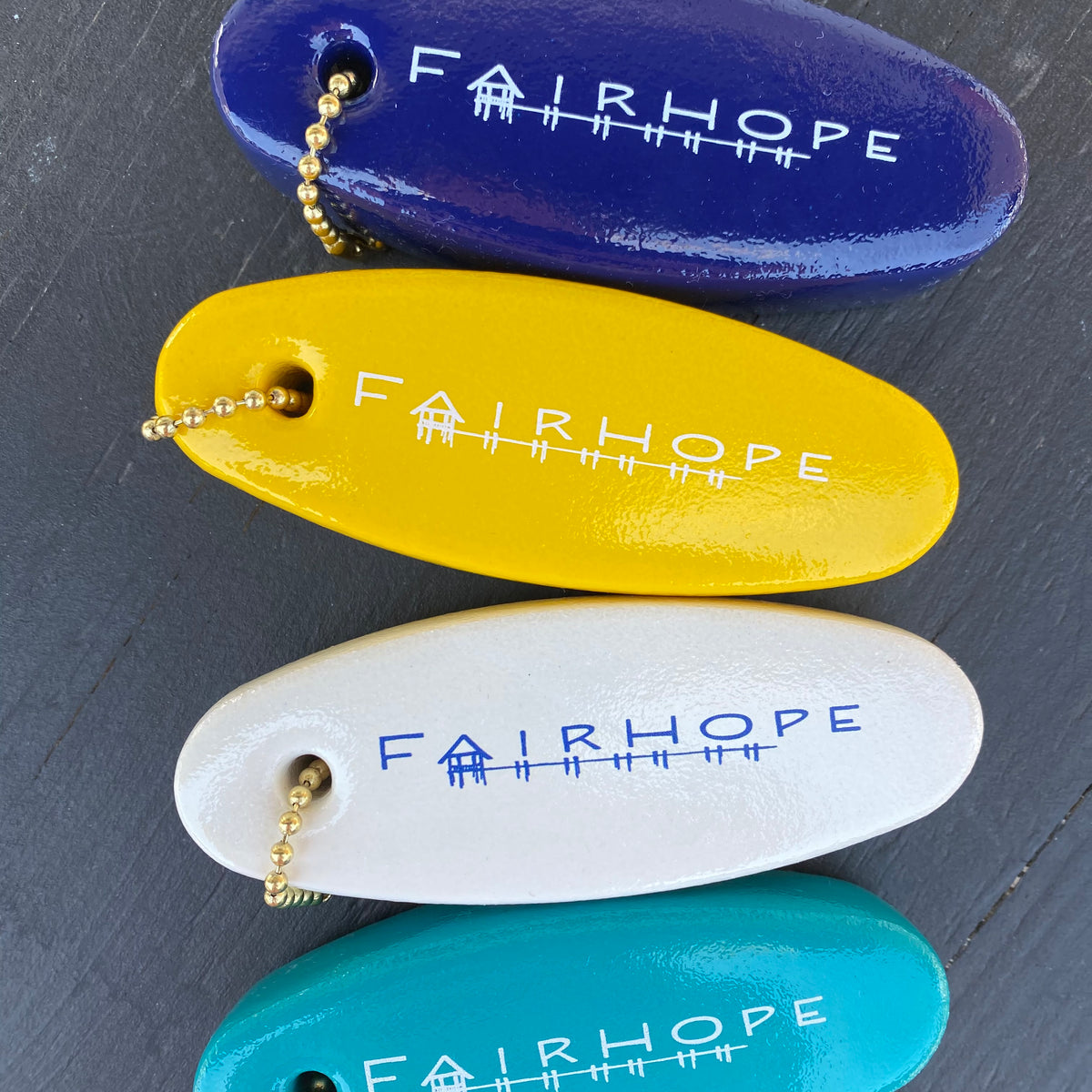 Yellow, blue, white, teal boat key fob from the Fairhope store