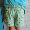 Close up of green bermies swimming shorts with pineapple design